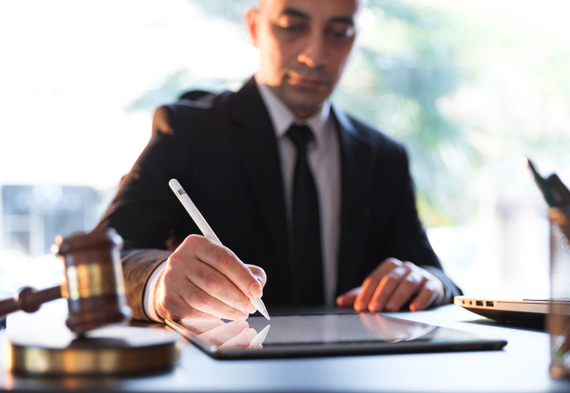 Man with ipad in suit