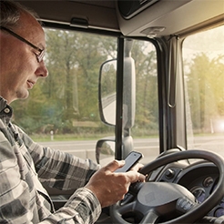 photo of truck driver on phone while driving