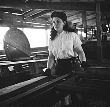 photo Barbara Webber edges the rough sides off a pine board.