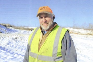 photo of Dave Berthiaume on the site of his final timber harvest.