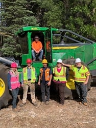 photo of group of Shasta students in front of forestry equipment