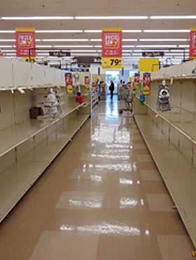 photo of grocery store showing empty shelves