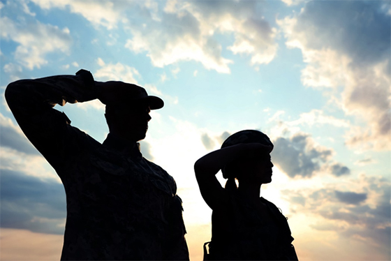 Image of 2 veterans saluting