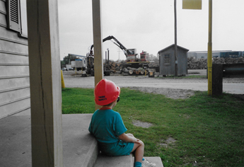 Child with orange hat on porch