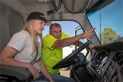 male and female inside cabin of forestry truck